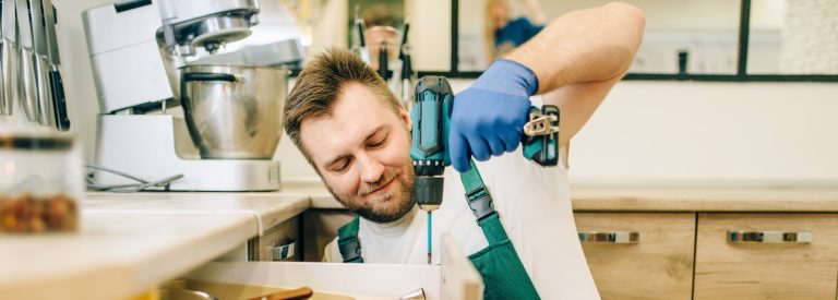 repairman-in-uniform-holds-screwdriver-technician-2023-11-27-05-23-52-utc-crop