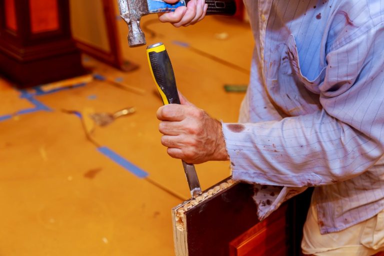 carpenter-makes-a-hole-in-new-wooden-door-for-the-2023-11-27-05-37-05-utc