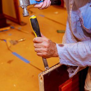carpenter-makes-a-hole-in-new-wooden-door-for-the-2023-11-27-05-37-05-utc